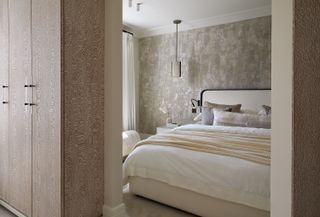 pale bedroom with gold wallpaper