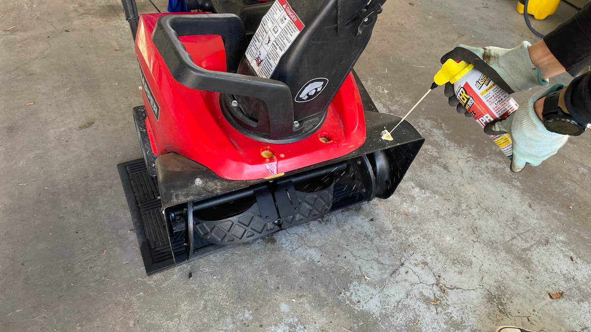 Spraying snow blower