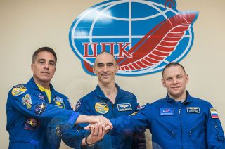Soyuz MS-16 crewmates Chris Cassidy of NASA (at left), Anatoli Ivanishin (at center) and Ivan Wagner, both of Roscosmos.