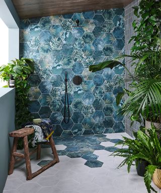Covered outdoor shower with jungle themed hexagonal tiles
