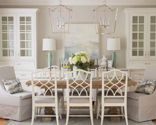Traditional cream dining room with two dressers and two pendant lights