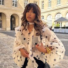 Influencer wears a polka dot blouse