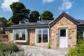 stone clad bungalow exterior with picture window