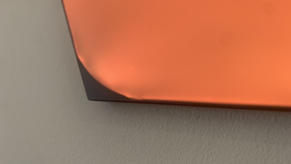 The edge of the nanolead shapes panels, showing slight disruption/fraying to the light