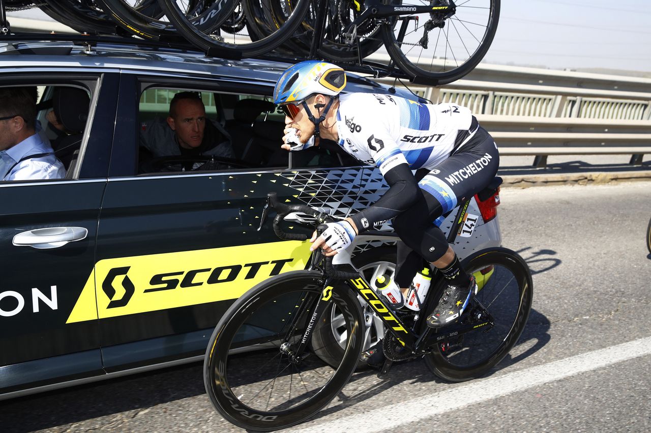 European champion Matteo Trentin consults with the Mitchelton-Scott team car.