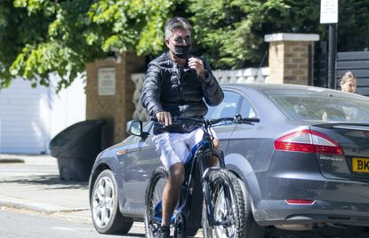 Simon Cowell riding an e-bike