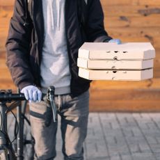 delivery man with cycle and parcel