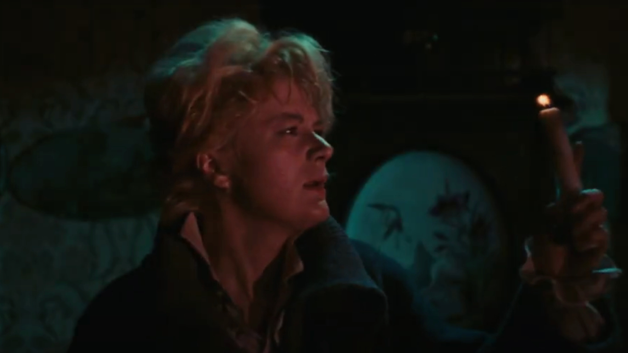 Frightened nurse holding a candle in Black Sabbath