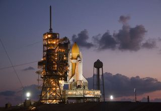 The sun rises on the space shuttle Discovery at the Kennedy Space Center.