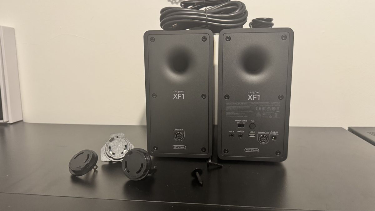 Creative XF1 speakers on a black desk