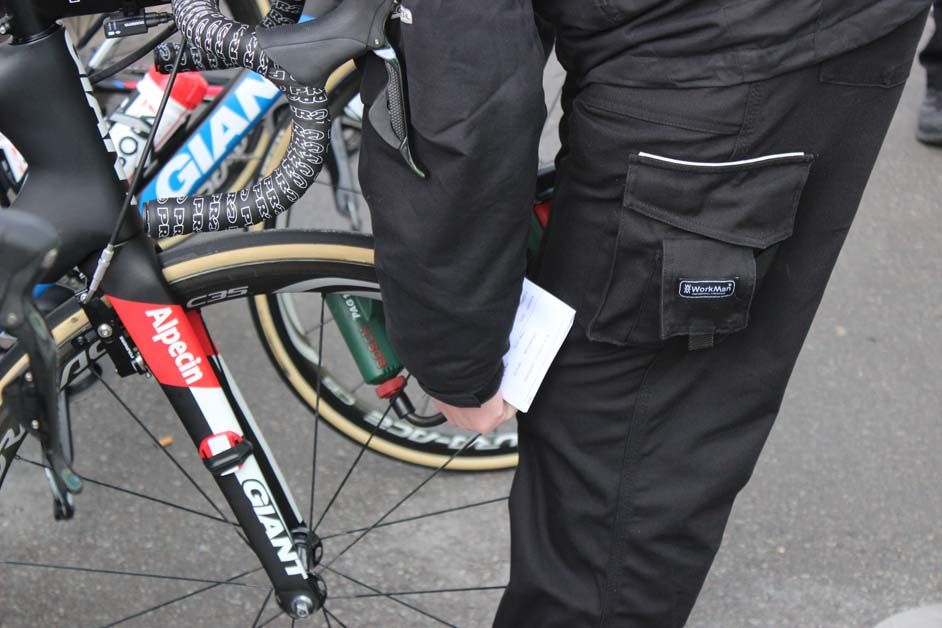 One of the Giant-Alpecin mechanics makes sure that all the tyres have the right pressure