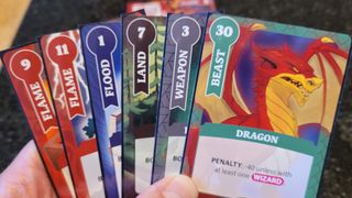 A selection of cards from Fantasy Realms Deluxe being held up