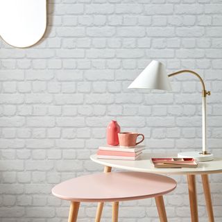 camden brick wallpaper with lamp on table and books