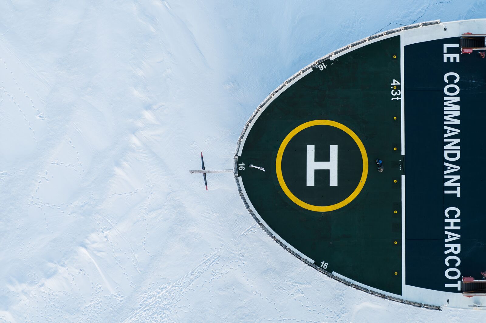 Aerial view of one end of an ice breaker boat in the North Pole with a visible helipad