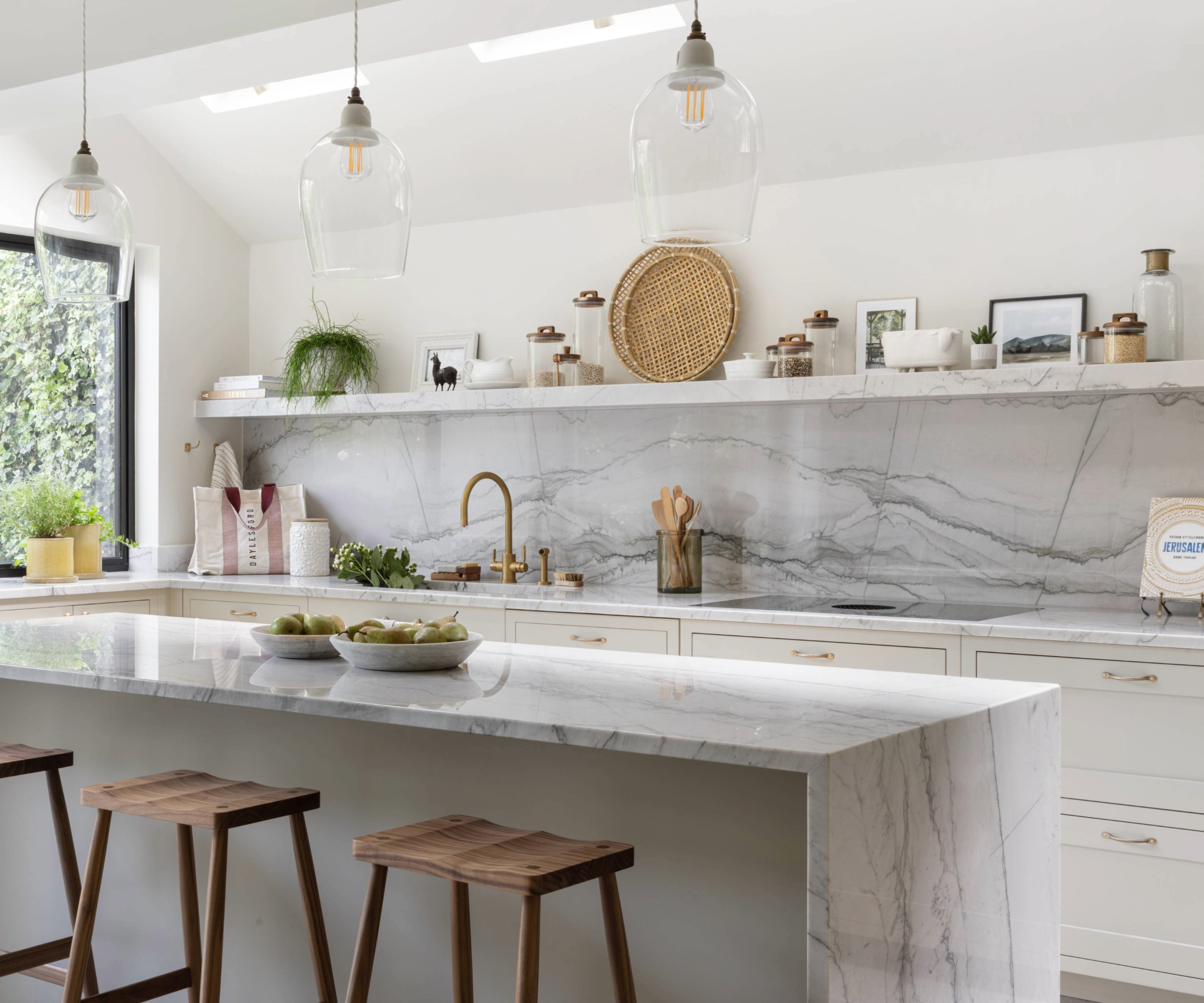 Kitchen with marble worktops and a mix of open shelving and wall cabinets