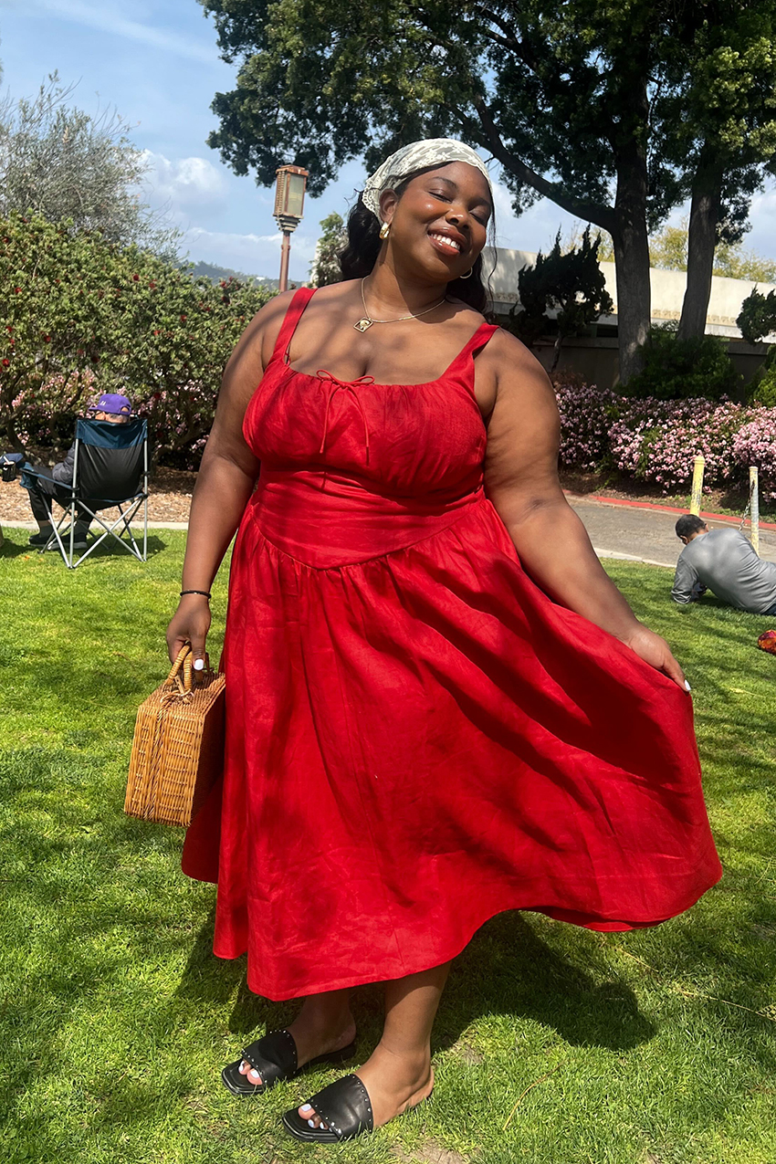 a woman wearing a red dress and black sandals