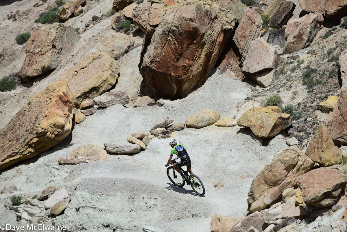 Alex Grant (Ridebiker) descending off-camber, loose pumice