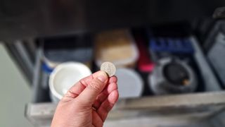 Holding a coin in front of a freezer