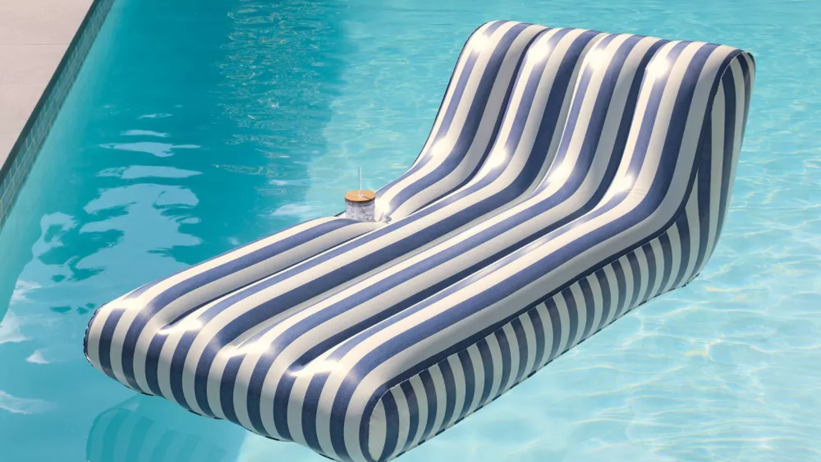 a striped blue and white pool float in a pool