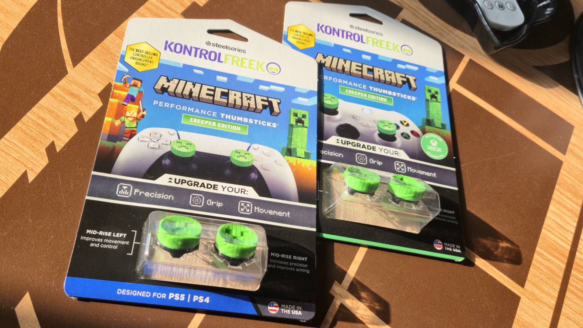 Photo by Rosalie Newcombe of the Creeper thumbsticks still in its packaging while laying on a wooden coffee table.