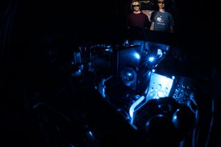 Chris Ørum and Steven Armstrong Jones work on the laser ALPHA experiment to find out the properties of light emitted by antihydrogen.