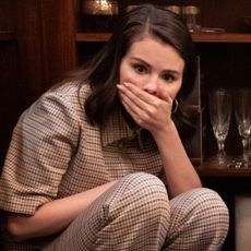 selena gomez covers her hand over her mouth in a look of surprise in only murders in the building season 5