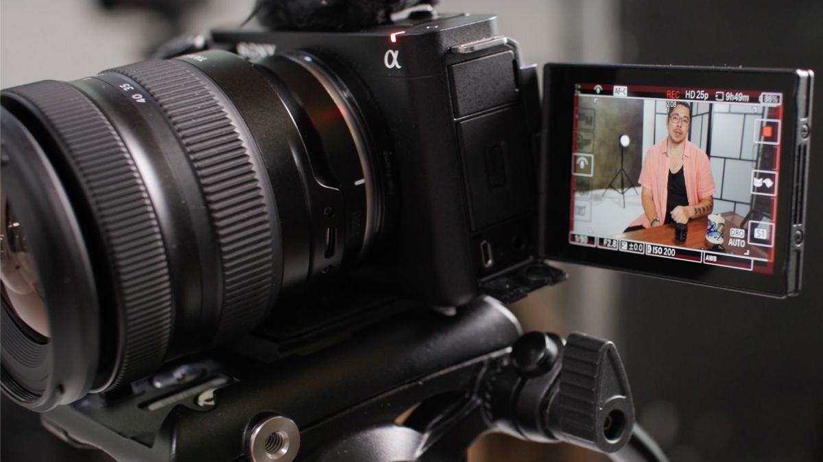 Close-up of the Sony ZV-E10, on a tripod, filming DCW editor James Artaius who is visible on the rear screen