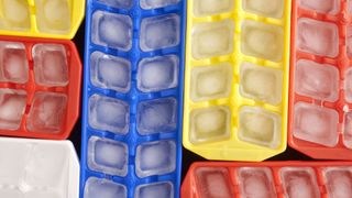 Blue, yellow, white and red ice cube trays