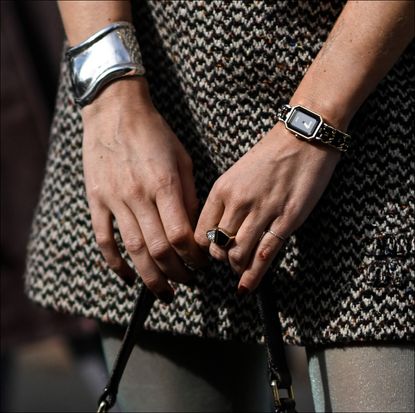 A guest is seen with a black Miu Miu bag outside the Miu Miu show during the Womenswear Spring/Summer 2024 as part of Paris Fashion Week on October 03, 2023 in Paris, France. 