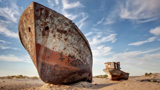 A deserted ship on a dry sand bed sits in what was the Aral Sea