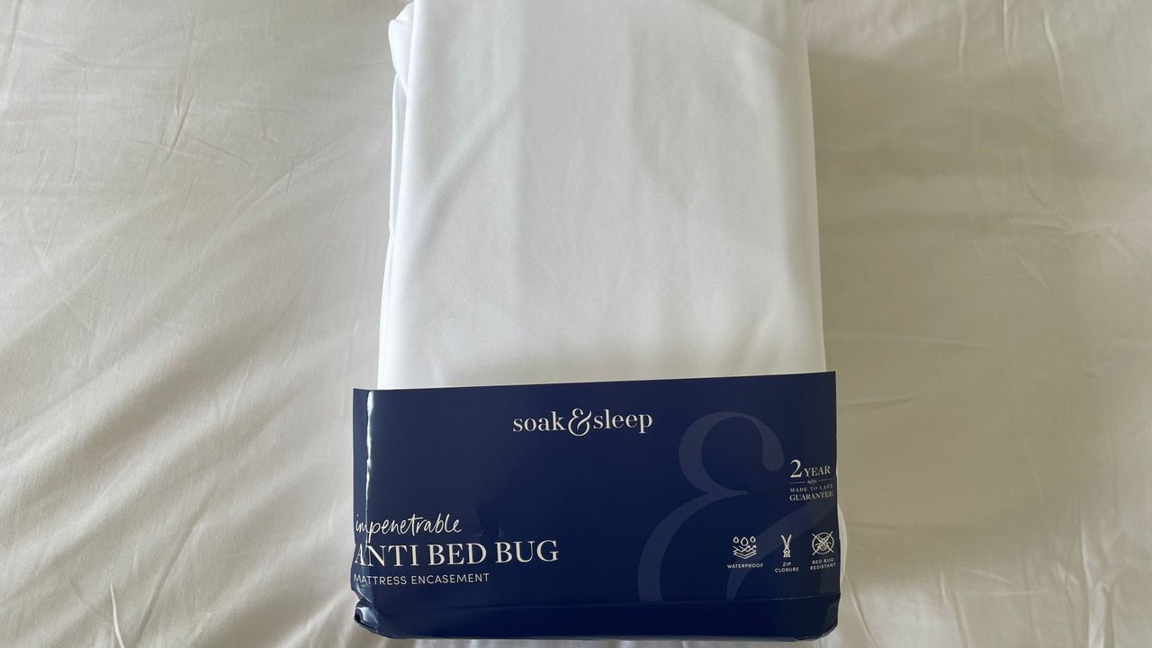 Soak &amp; Sleep Anti-Bed Bug Mattress Encasement in its packaging, on the bed