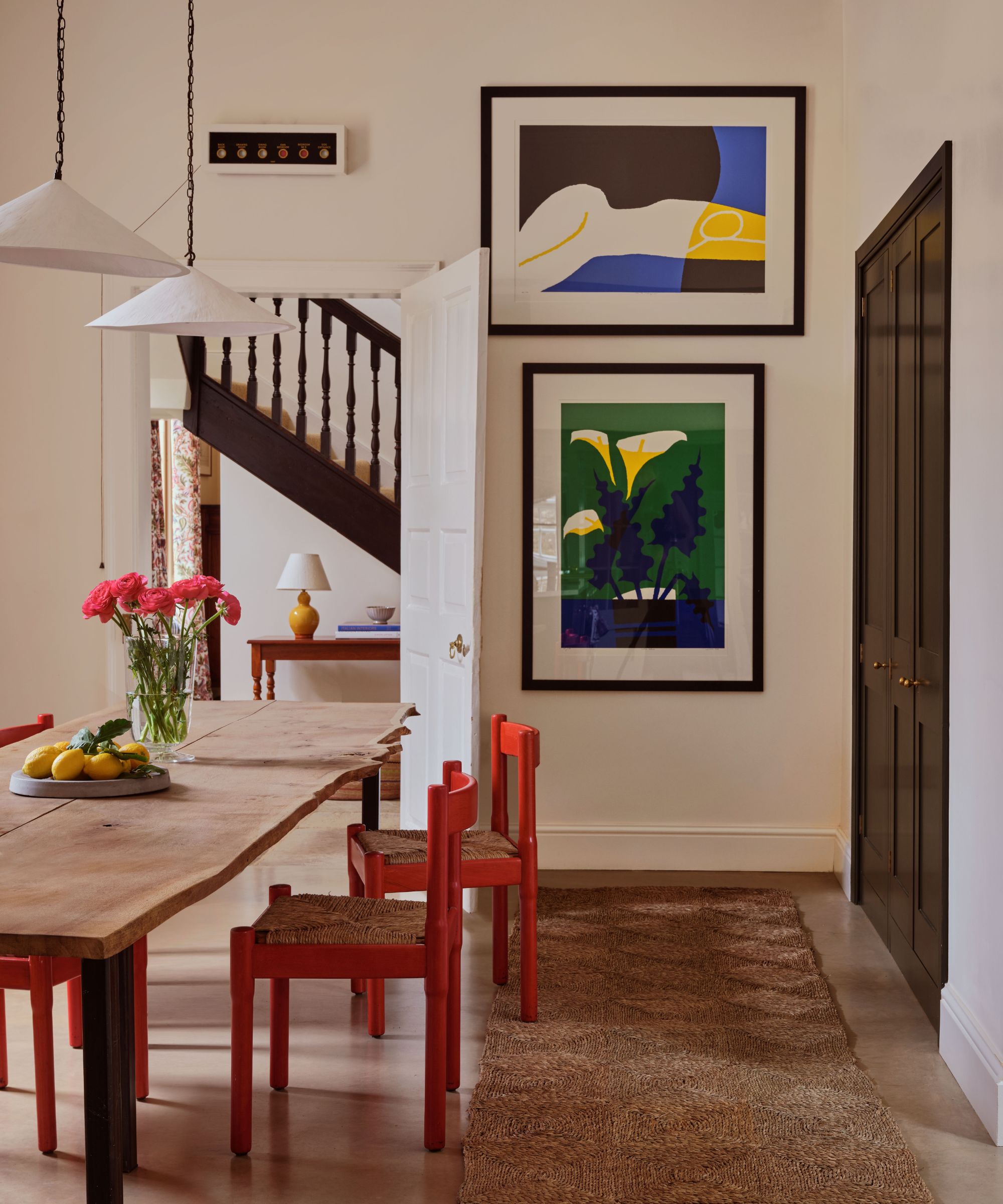 Cream dining room with red chairs