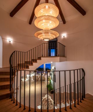 Malibu Mansion spiral staircase with luxury hanging light