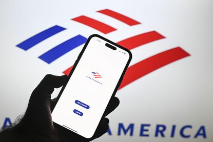 In this photo illustration, logos of Bank of America are displayed on mobile phone screen and computer screen 