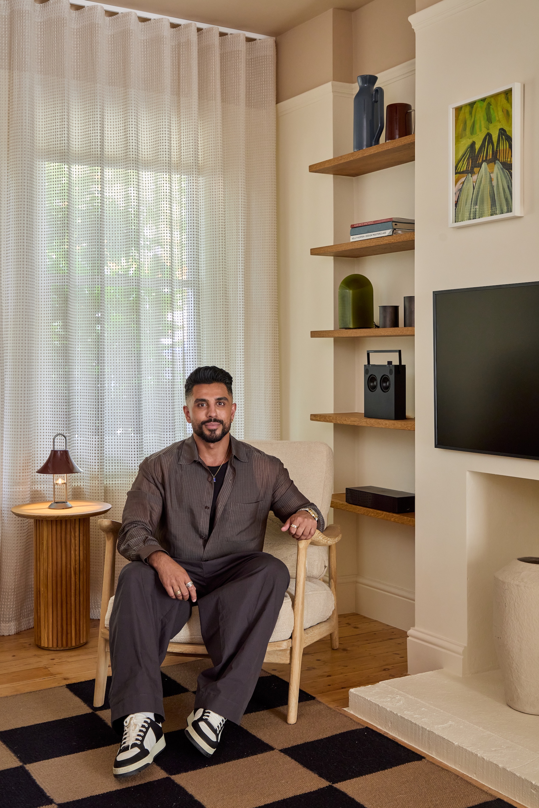 Omar Bhatti, young man with beard, sitting in an armchair