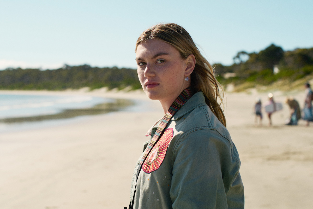 shannon berry as bronte standing on a beach in the survivors