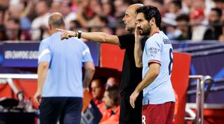 Manchester City manager Pep Guardiola gives instructions to Ilkay Gundogan during the UEFA Champions League group stage match between Sevilla and Manchester City at the Estadio Ramon Sanchez-Pizjuan on 6 September, 2022 in Seville, Spain.
