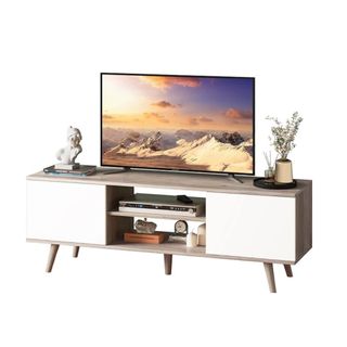 A white TV stand with a TV and decor on it