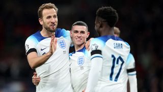 Harry Kane (L) celebrates with teammates ahead of the North Macedonia vs England live stream