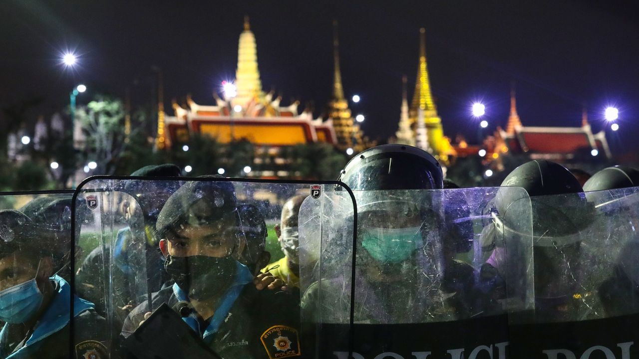 Police stand guard in front of the Grand Palace as protesters take part in an anti-government demonstration in Bangkok