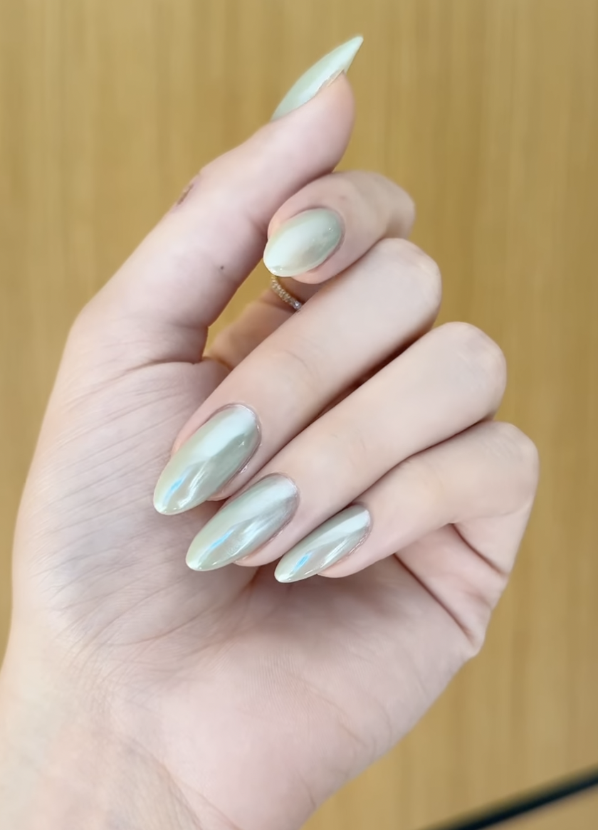 Long almond nails with a pale jade green chrome finish