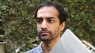 Nirav Patel holding a Framework laptop