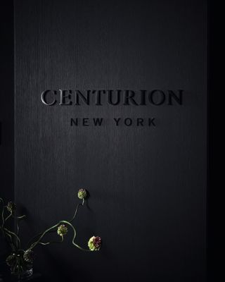 Centurion New York logo on black wall at entrance to the space