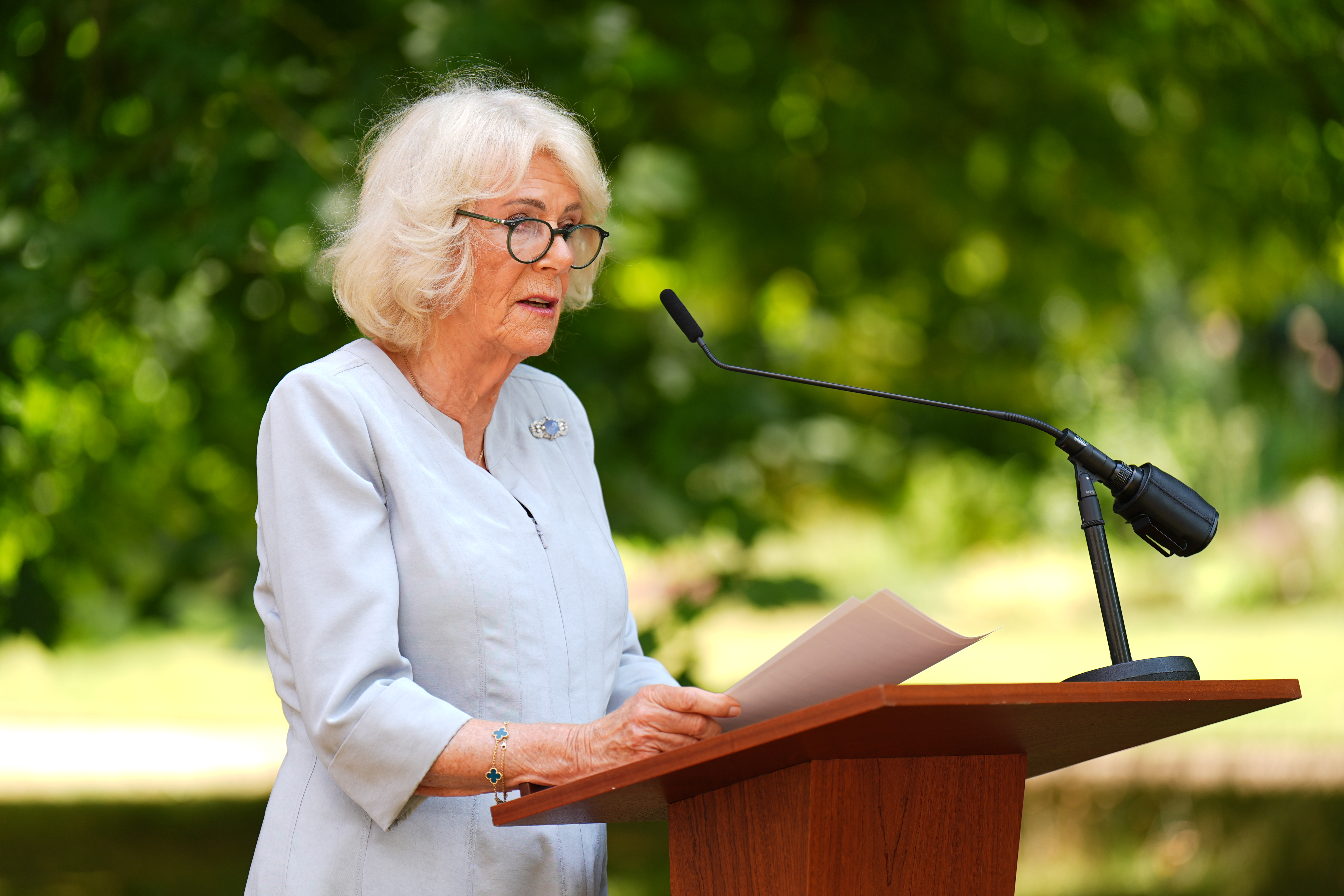 Queen Camilla speaking at a podium