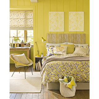 bedrooom with yellow wall and wooden floor