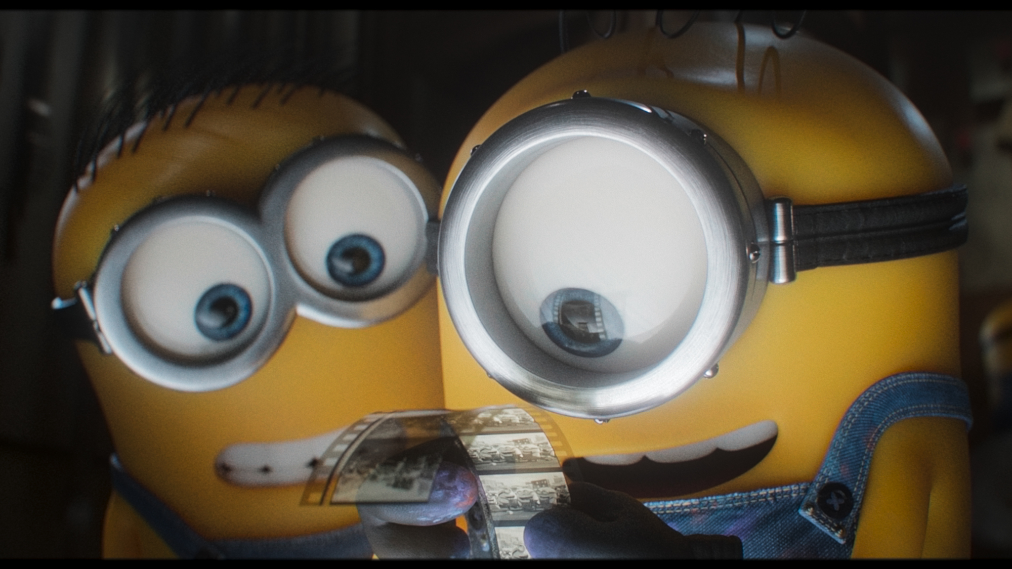 Minions look at a film reel in Minions &amp; Monsters.