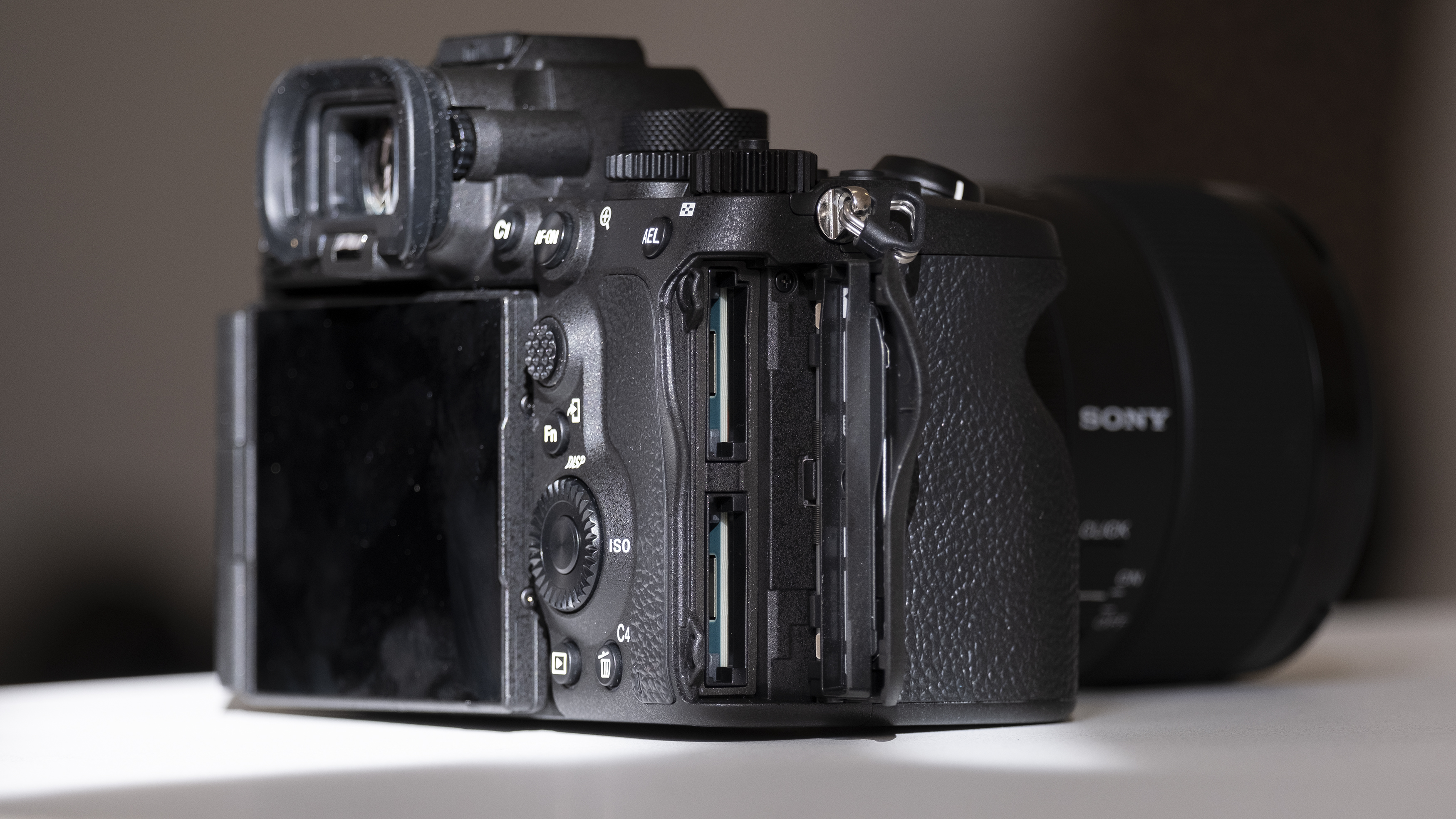 The Sony A7R V camera sitting on a wooden floor