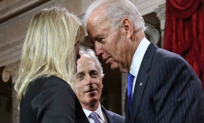 Vice President Joe Biden whispers to Sen. Bob Corker&amp;#039;s wife. The senator looks none too pleased.