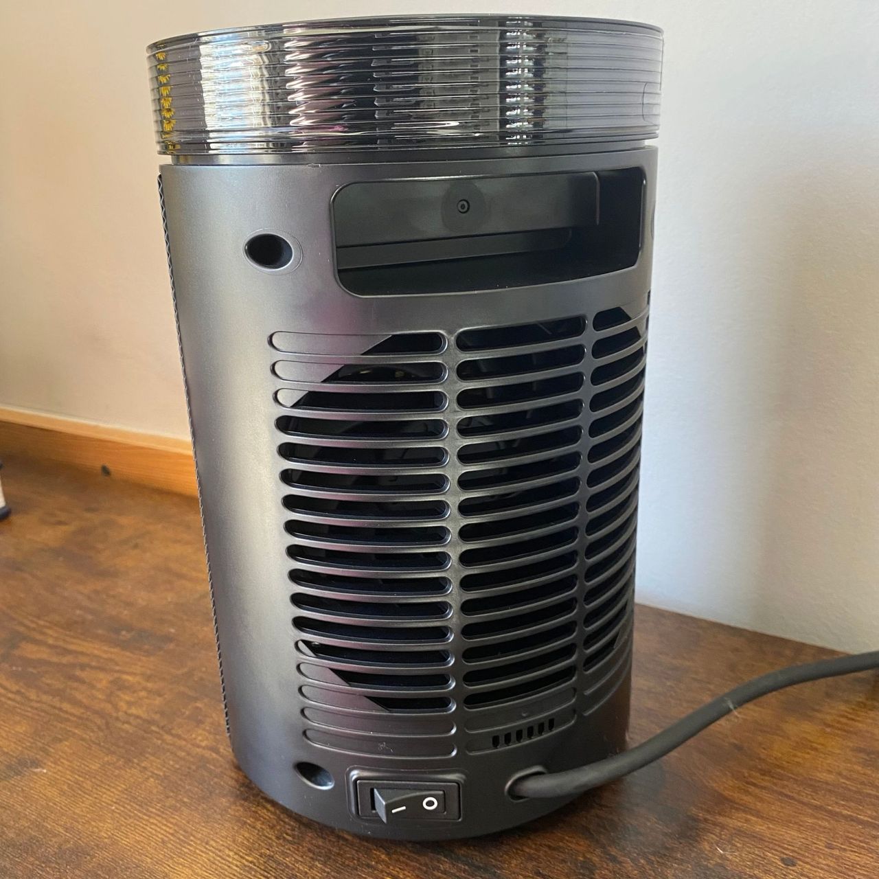 Rear view of the Morphy Richards HeatFlux 1.5kW Ceramic Fan Heater, sitting on a wood surface