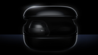 Some dark Samsung earbuds, backlit, on black background